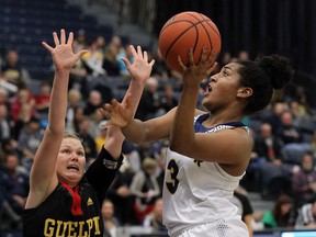 In this photo from Nov. 16, 2016, Kayah Clarke,  of the University of Windsor Lancers, drives to the bucket past University of Guelph Gryphons Samantha Renshaw at the St. Denis Centre in Windsor. Clarke sustained a serious knee injury in the Lancers game against Laurier on Feb. 8, 2017.