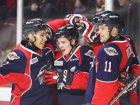 Windsor Spitfires newcomers Dede Cato, left, Tyler Angle and Maddux Rychel celebrate Angle's first goal against the Saginaw Spirit in OHL action at the WFCU Centre Feb. 2, 2017.