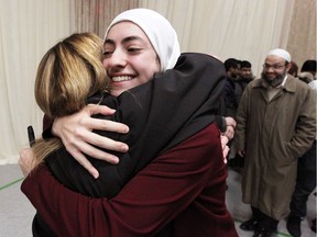 Lina Chaker is embraced by Laura Hasulo, left, who spoke during a public vigil in remembrance of victims of Quebec City mosque shooting. The event was hosted by Windsor Islamic Council at Windsor Mosque Friday, Feb. 3, 2017.