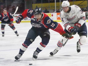 Windsor Spitfires Jeremiah Addison holds off Oshawa Generals Greyden Gottschalk in second-period action at WFCU Centre on Feb. 9, 2017.