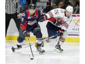 Windsor Spitfires Sean Day, left, controls the puck against Oshawa Generals Kenny Huether in OHL action from WFCU Centre on Feb. 9, 2017.