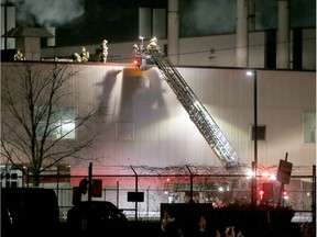 Windsor firefighters work to put out a blaze on the roof of Nemak plant on Feb. 17, 2017.