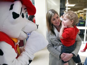 Maverick Larade, 18 months old, throws a kiss to Paw Patrol character Marshall, left, while being held by his mother Alysha Sutherland during Family Day event at Tecumseh Mall, February 20, 2017.
