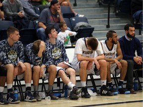 Windsor Lancers men's basketball players show their dejection in the closing seconds of the OUA playoff game against the McMaster Marauders at the St. Denis Centre on Feb. 22, 2017. Windsor lost 71-63.