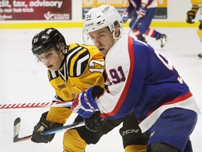 Drake Rymsha, left, of Sarnia Sting collides with Windsor Spitfires Aaron Luchuk in OHL first-period action from WFCU Centre on Feb. 26, 2017. Sarnia beat Spits 4-2.