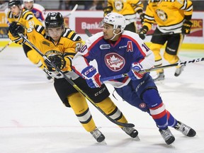 Windsor Spitfires Jeremiah Addison, right, is tracked by Sarnia Sting's Franco Sproviero in OHL first-period action from the WFCU Centre on Feb. 26, 2017.