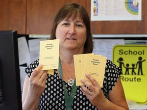 Judy Allen, manager healthy schools department for the Windsor-Essex County Health Unit hold immunization cards Sept. 02, 2016.