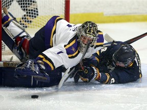 Windsor's Mike Christou crashes into Laurier goaltender Colin Furlong during OUA exhibition hockey action on Sept. 30, 2015. Christou scored his first goal of the season on Feb. 25, 2017 to help the Lancers eliminate the Ryerson Rams in their divisional semifinal.