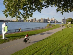 A cyclist and walkers use the pathway along the Detroit River in this photo from September 2006.