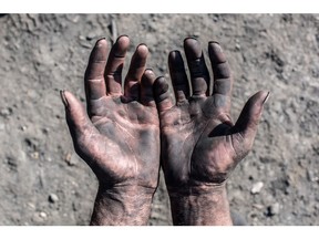Migrant worker's hands. Photo by Getty Images.