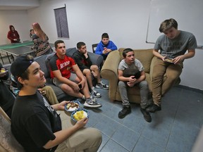 A group of boys watch television at the grand opening of the new location of the LaSalle Hangout for Youth, Saturday, Feb. 18, 2017.