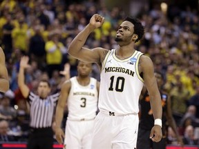 Michigan guard Derrick Walton Jr. (10) celebrates after Michigan defeated Oklahoma State 92-91 in a first-round game in the men&#039;s NCAA college basketball tournament in Indianapolis, Friday, March 17, 2017. (AP Photo/Michael Conroy)