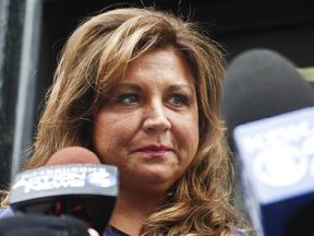 FILE- In this June 27, 2016, file photo, &ampquot;Dance Moms&ampquot; star Abby Lee Miller leaves federal court after pleading guilty in Pittsburgh to bankruptcy fraud and failing to report thousands of dollars in Australian currency she brought into the country. Miller posted on Instagram March 26, 2017, that she quit the Lifetime series. (AP Photo/Keith Srakocic, File)