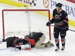 Carolina Hurricanes&#039; Victor Rask (49), of Sweden, stands by while goalie Eddie Lack (31), of Sweden, is attended to following an injury during overtime in an NHL hockey game against the Detroit Red Wings in Raleigh, N.C., Monday, March 27, 2017. Detroit won 4-3. (AP Photo/Gerry Broome)