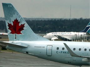 A Westjet plane gets ready for take off as it passes an Air Canada jet at Calgary's international airport in this undated photo.