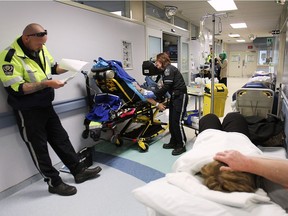 Paramedics with the Essex-Windsor Emergency Medical Services are shown in the emergency department at the Windsor Regional Hospital Ouellette Campus on Wednesday, May 20, 2015. Local health officials announced changes that would allow paramedics to spend less time with "ambulance off load delays" such as the individuals shown here.