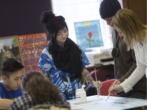 From left to right, Jordans Lao, Courtney Gregorian, Jasmin Blanchard, Teajai Travis, and Emily Carruthers work on a mural for VIBE Arts 150+ Reasons at the Bloomfield House, Saturday, March 18, 2017.