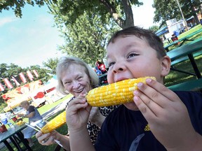 Declan Sampson chows down at the Tecumseh Corn Festival in August 2016 while his grandmother Nancy Topolnicki looks on with approval.