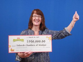 Debbie Chambers of WIndsor holds the $250,000 prize cheque she won playing Instant Crossword Deluxe.