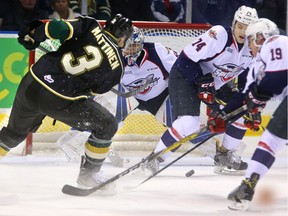 Defenceman Nicolas Mattinen of the London Knights fires a shot at goalie Michael DiPietro of the Windsor Spitfires during their Feb. 24, 2017 game at Budweiser Gardens in London. Sean Day (74) and Adam Laishram (19) of the Spits were in on the play.