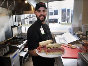 The Downtown Mission's Do Good Deli officially opened on Monday, March 20, 2017. Roger Poirier, a cook at the deli displays a freshly made sandwich during the event.