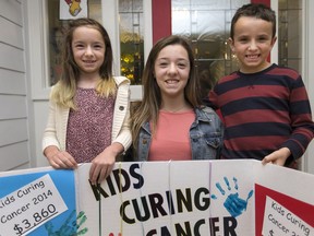 Lauren Baillargeon, 12, centre, and her seven-year-old twin siblings, Kierstyn Baillargeon and Ty Baillargeon, are pictured at the Ronald McDonald House at Windsor Regional Hospital - Met Campus after donating $8,304 they raised, on March 26, 2017.