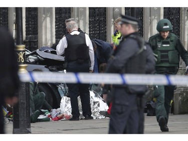 Emergency personnel tend to an injured person close to the Palace of Westminster, London, March 22, 2017.