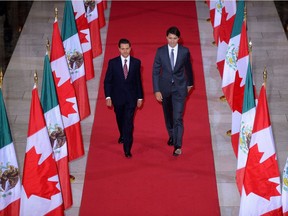 Prime Minister Justin Trudeau and Mexican President Enrique Pena Nieto walk down the Hall of Honour on their way to a signing ceremony on NAFTA on Parliament Hill in Ottawa on June 28, 2016.