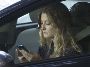 A driver uses her cellphone while sitting in traffic in Sacramento, Calif., on June 22, 2016.