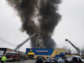 Firefighters battle a fire behind J&B Auto Parts on Provincial Road in Windsor on Thursday, March 9, 2017.