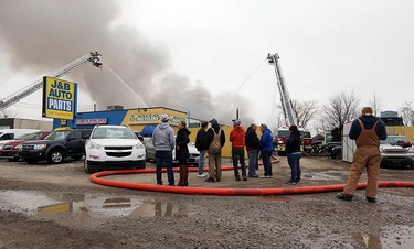 Firefighters battle a fire behind J&B Auto Parts on Provincial Road in Windsor on Thursday, March 9, 2017.