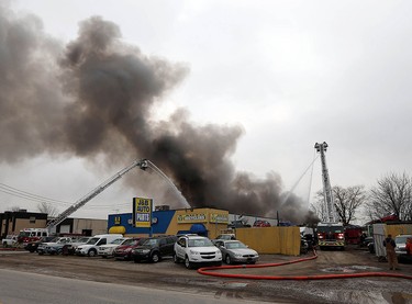 Firefighters battle a fire behind J&B Auto Parts on Provincial Road in Windsor on Thursday, March 9, 2017.