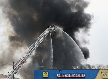 Firefighters battle a fire behind J&B Auto Parts on Provincial Road in Windsor on Thursday, March 9, 2017.