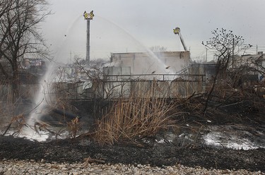 Firefighters battle a fire behind J&B Auto Parts on Provincial Road in Windsor on Thursday, March 9, 2017.