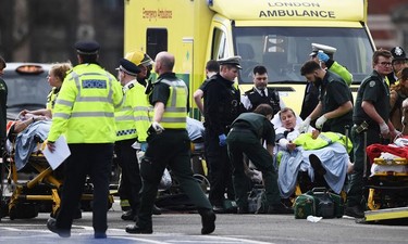 Members of the public are treated by emergency services near Westminster Bridge and the Houses of Parliament on March 22, 2017 in London, England. A police officer has been stabbed near to the British Parliament and the alleged assailant shot by armed police. Scotland Yard report they have been called to an incident on Westminster Bridge where several people have been injured by a car.