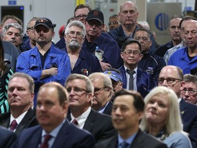 Ford workers, standing at the Ford Essex Engine Plant in Windsor, Ont., listen to a major investment announcement on March 30, 2017.