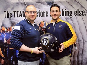 Joe D'Amore, left, head coach of the University of Windsor Lancers football team poses with Vince Flamia, who was named special teams co-ordinator and head recruiter on March 16, 2017.