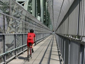 A cyclist rides on the Jacques Cartier Bridge in Montreal.