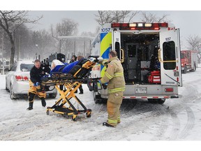 Lakeshore firefighters transport a woman that was pulled from the Puce River Harbour Marina on March 14, 2017. Mike Dunn, a nearby resident heard the woman scream and was able to hang onto the woman and eventually pulled her onto a dock when a second man arrived to assist.