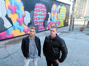 Windsor artists Colin MacDonald (Thrack Anderson) and David Creed by their mural overlooking the Multicultural Council of Windsor and Essex County parking lot on March 8, 2017.