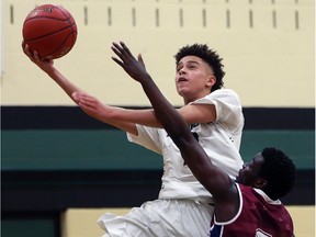 Andreas McBounds, left, of Lajeunesse drives past Babacar Fall of Oakville Ste. Trinite les Loups during an OFSAA boys' A basketball game on March 6, 2017 in Windsor.