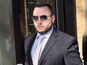OPP Const. Jamie Porto leaves Superior Court in Windsor, Ont., on March 22, 2017 after receiving a 12-month driving prohibition and a $2,500 fine for his conviction of dangerous driving causing bodily harm for an October 2014 crash in St. Joachim.