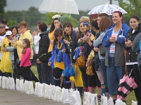 Spectators look on at the Vollmer Complex in LaSalle during the Relay for Life on June 20, 2014.
