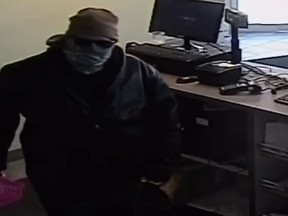 A person wanted in connection to a robbery at a pharmacy in the 100 block of Erie Street East on March 12, 2017 is pictured in this surveillance photo.