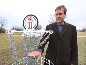 Tecumseh Parks and Rec director Paul Anthony displays a disc catcher on Lakewood Park, Manning Road south of Riverside Drive East on March 27, 2017.