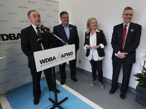 Michael Cautillo, president and CEO WDBA, left; Dwight Duncan, chair WDBA board of directors; Lori Newton, executive director of Bike Windsor Essex; and Todd Scott, executive director of Detroit Greenways Coalition, take part in a news conference at Bike Windsor Essex in Windsor on March 1, 2017. Bike lanes and pedestrian access will be integrated into the design of the Gordie Howe Bridge.