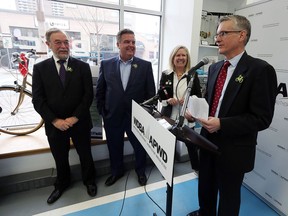 Michael Cautillo, left, president and CEO WDBA, Dwight Duncan, chair WDBA board of directors, Lori Newton, executive director of Bike Windsor Essex, and Todd Scott, executive director of Detroit Greenways Coalition, take part in a news conference at Bike Windsor Essex in Windsor on March 1, 2017. Bike lanes and pedestrian access to the Gordie Howe Bridge was announced during the event.