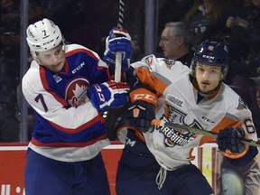 Windsor Spitfires Tyler Angle gets tied up with Flint Firebirds Sean Allen during first-period Ontario Hockey League action at the WFCU Centre in Windsor, Ont., on March 12, 2017.