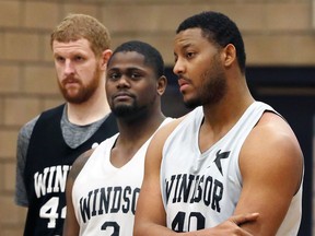 Rudolphe Joly, right, listens to coach Bill Jones's instruction with other Windsor Express big men Nick Evans, left, and DeAndre Thomas at WFCU Centre on March 14, 2017.