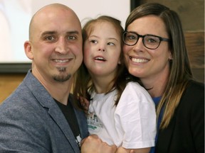 Hazel Seguin, 5, snuggles with her parents Matt Seguin and Stephanie Seguin during launch of The Chasing Hazel Foundation Monday March 20, 2017.
